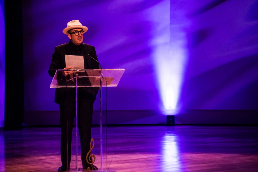 Elvis Costello speaks at Allen Toussaint's funeral. Photo by Noe Cugny.